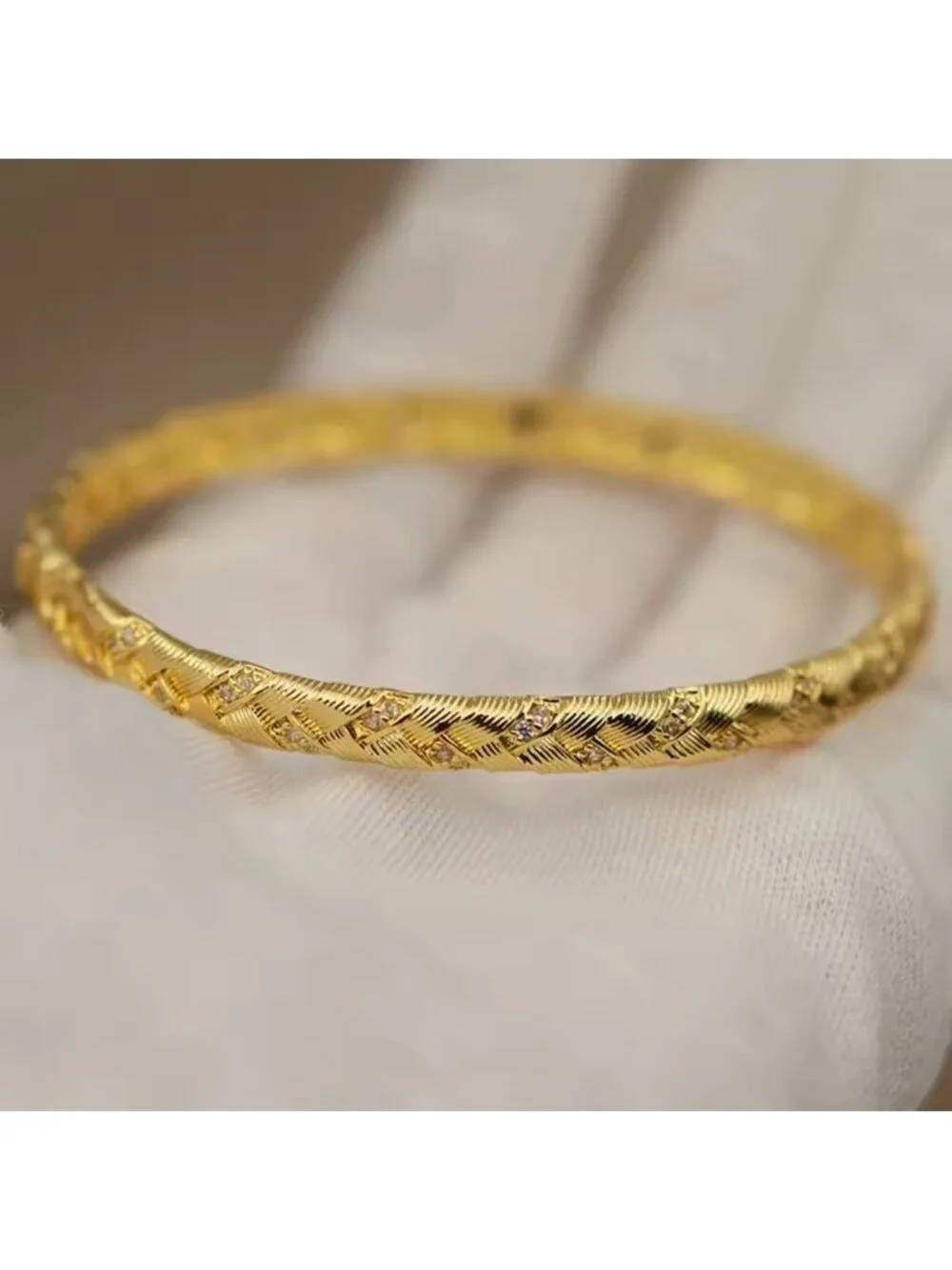 Gold Tone Braided Bangle with Clear Stone Accents